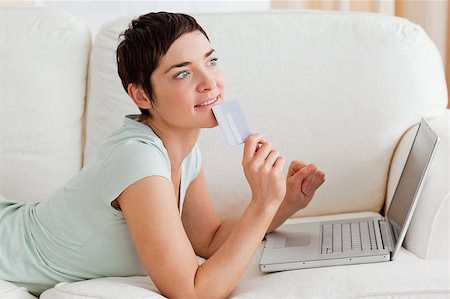 simsearch:400-04410667,k - Pensive young woman buying online in her living room Stock Photo - Budget Royalty-Free & Subscription, Code: 400-04410666
