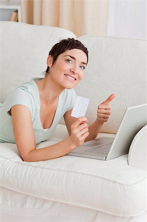 simsearch:400-04410667,k - Portrait of a happy woman shopping online witth her thumb up Stock Photo - Budget Royalty-Free & Subscription, Code: 400-04410663
