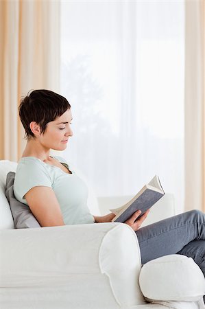 simsearch:400-04418460,k - Portrait of a short-haired woman reading a book in her liviing room Stock Photo - Budget Royalty-Free & Subscription, Code: 400-04410675
