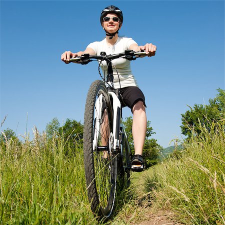 Young girl riding a bike on a field path - offroad Stock Photo - Budget Royalty-Free & Subscription, Code: 400-04411539