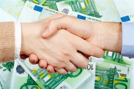 simsearch:400-04333648,k - Business handshake over a euro money background Stock Photo - Budget Royalty-Free & Subscription, Code: 400-04425478