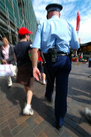 cop in blue uniform arresting or investigating a young man, picture is motion blured Stock Photo - Budget Royalty-Free & Subscription, Code: 400-04428006