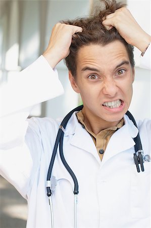 stethoscope funny - Close-up portrait of a young angry doctor Stock Photo - Budget Royalty-Free & Subscription, Code: 400-04421028