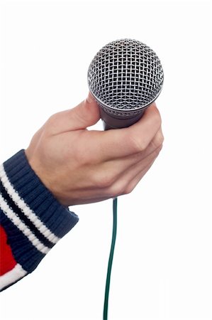simsearch:400-06954069,k - Hand holding a microphone over a white background. Mic on focus Photographie de stock - Aubaine LD & Abonnement, Code: 400-04434031