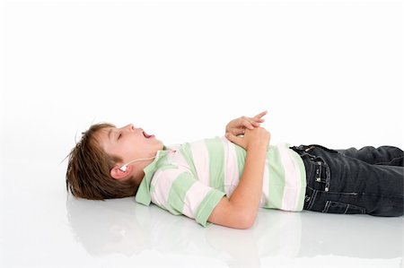 simsearch:400-05748462,k - Child lying down listening to mp3 music Stock Photo - Budget Royalty-Free & Subscription, Code: 400-04435202