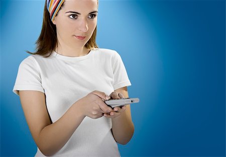 Woman with a remote control over a blue background Stock Photo - Budget Royalty-Free & Subscription, Code: 400-04438274
