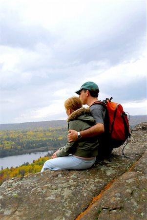 person sitting cliff edge - A parent and a child sitting on a cliff edge enjoying scenic view Stock Photo - Budget Royalty-Free & Subscription, Code: 400-04430451