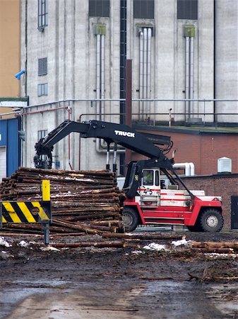 sawmill wood industry - portrait of truck loading timber to a boat Stock Photo - Budget Royalty-Free & Subscription, Code: 400-04431818