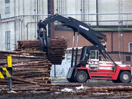 sawmill wood industry - portrait of truck loading timber to a boat Stock Photo - Budget Royalty-Free & Subscription, Code: 400-04431819