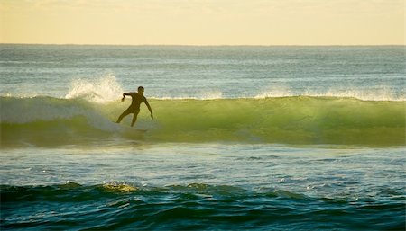 Early morning Surfer Catches a wave in the surf Stock Photo - Budget Royalty-Free & Subscription, Code: 400-04447865