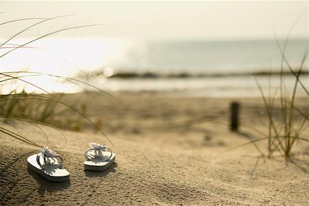 Two white sandals on sandy beach with ocean in background. Stock Photo - Budget Royalty-Free & Subscription, Code: 400-04449113