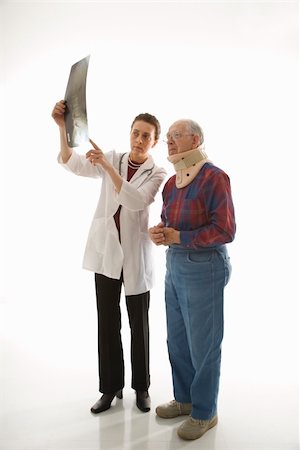 Mid-adult Caucasian female doctor showing x-ray to elderly Caucasian male in neck brace. Stock Photo - Budget Royalty-Free & Subscription, Code: 400-04449864