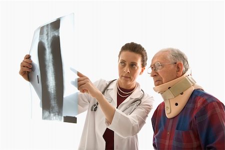 Mid-adult Caucasian female doctor ponting at x-ray with elderly Caucasian male in neck brace looks on. Stock Photo - Budget Royalty-Free & Subscription, Code: 400-04449865