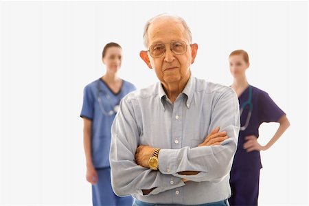 Elderly Caucasian male in foreground with two Caucasian females in the background. Stock Photo - Budget Royalty-Free & Subscription, Code: 400-04449875
