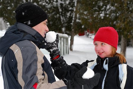 snow ball fights - Father and child holding snowballs in winter park Stock Photo - Budget Royalty-Free & Subscription, Code: 400-04440564