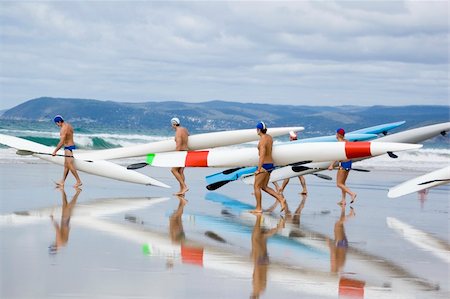 Iron men racers carry their boats to the water in preparation for a competition. Stock Photo - Budget Royalty-Free & Subscription, Code: 400-04441373