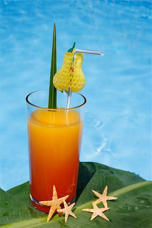 Bright drink by swimming pool with banana leaf Stock Photo - Budget Royalty-Free & Subscription, Code: 400-04441984