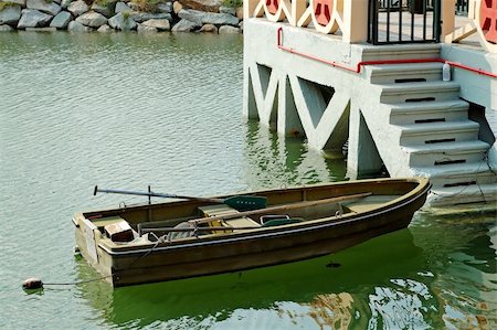 simsearch:400-04433053,k - A rowboat anchored beside an antique marina Stock Photo - Budget Royalty-Free & Subscription, Code: 400-04455748