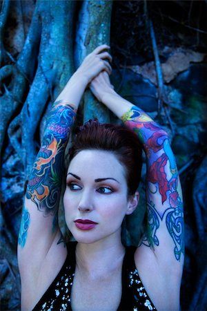 simsearch:400-04450827,k - Blue-toned portrait of tattooed Caucasian woman with Banyan tree in Maui, Hawaii, USA. Stock Photo - Budget Royalty-Free & Subscription, Code: 400-04450841