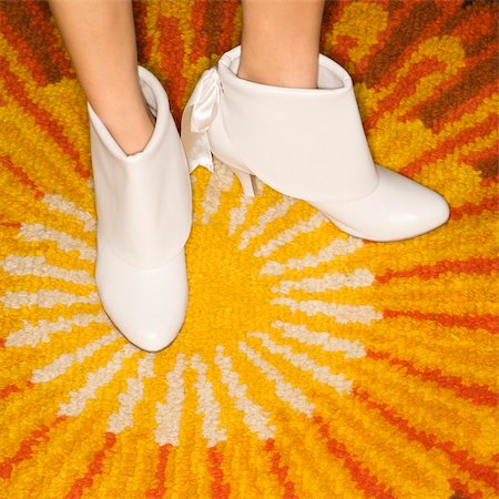 simsearch:400-04450069,k - Close-up of Caucasian mid-adult female feet in white vintage boots against sunburst rug. Stock Photo - Budget Royalty-Free & Subscription, Code: 400-04451390