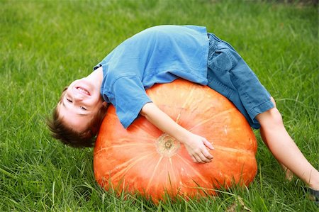 Boy Playing on top of a Huge Pumpkin Stock Photo - Budget Royalty-Free & Subscription, Code: 400-04464131