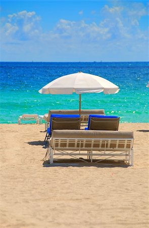 Empty beach lounge chairs under white umbrella Stock Photo - Budget Royalty-Free & Subscription, Code: 400-04465191