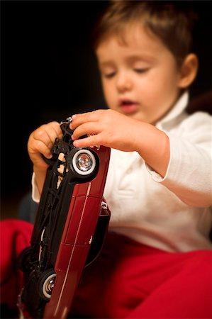 little boy playing indoor with model cars Stock Photo - Budget Royalty-Free & Subscription, Code: 400-04467629