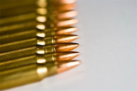 Row of rifle rounds on white sharp focus going to a nice blur Stock Photo - Budget Royalty-Free & Subscription, Code: 400-04475641