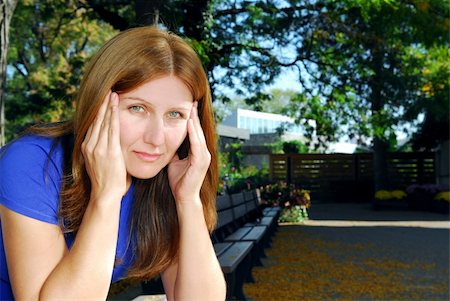 simsearch:400-04283915,k - Mature woman with a headache sitting on the park bench Stock Photo - Budget Royalty-Free & Subscription, Code: 400-04470036