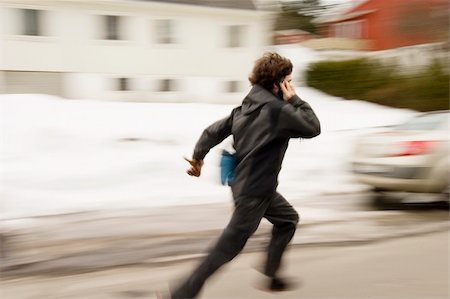 people running scared - A motion blur abstract of a person walking in a hurry talking on a cell phone Stock Photo - Budget Royalty-Free & Subscription, Code: 400-04470050