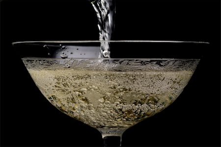 simsearch:400-07166551,k - Pouring champagne in a beautiful glass. black background. Stock Photo - Budget Royalty-Free & Subscription, Code: 400-04470624