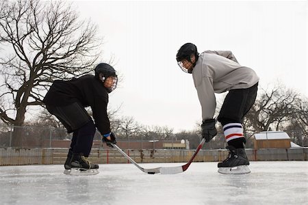 Two ice hockey player boys in uniform facing off on ice. Stock Photo - Budget Royalty-Free & Subscription, Code: 400-04471040