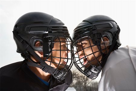 Two ice hockey players in uniform facing off trying to intimidate eachother. Stock Photo - Budget Royalty-Free & Subscription, Code: 400-04471041