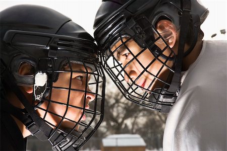Two ice hockey players in uniform facing off trying to intimidate eachother. Stock Photo - Budget Royalty-Free & Subscription, Code: 400-04471042