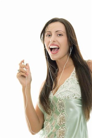 simsearch:400-04300097,k - Outgoing brunette woman listening to songs on an mp3 player, big smile, white background Stock Photo - Budget Royalty-Free & Subscription, Code: 400-04472164