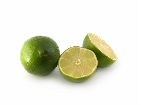 simsearch:400-04716078,k - One green lime and two halves liyng on the white background Stock Photo - Budget Royalty-Free & Subscription, Code: 400-04487288