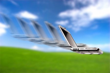 simsearch:700-05452103,k - Laptop flying over a beautiful green meadow Stock Photo - Budget Royalty-Free & Subscription, Code: 400-04487858