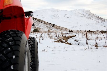 right side of a red quad with tyres in snow Stock Photo - Budget Royalty-Free & Subscription, Code: 400-04488852
