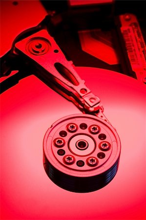 simsearch:400-05238336,k - Red lit hard drive platter highlight bottom Stock Photo - Budget Royalty-Free & Subscription, Code: 400-04489638