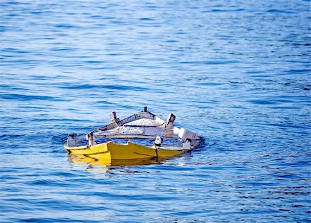 Abandoned small wooden fishing boat sunk in the sea Stock Photo - Budget Royalty-Free & Subscription, Code: 400-04480552