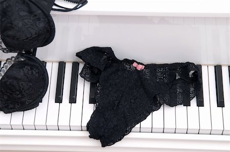 Set of ladies lace lingerie on the keyboard of a white baby grand piano. Stock Photo - Budget Royalty-Free & Subscription, Code: 400-04494372