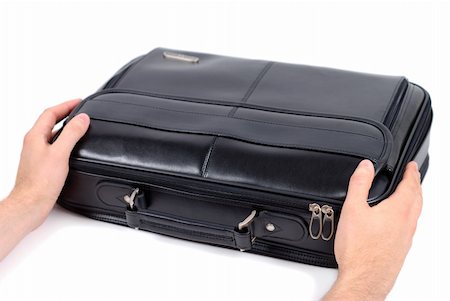 Male hands holding black briefcase over white background Stock Photo - Budget Royalty-Free & Subscription, Code: 400-04496798