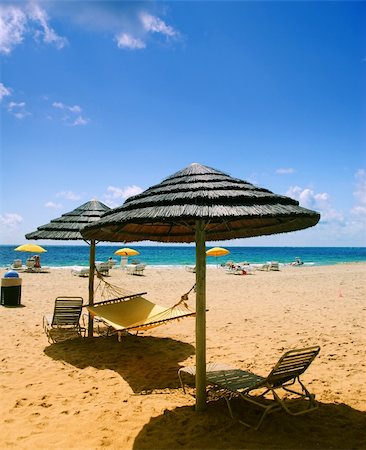 Beach lounge chairs under shade of umbrellas Stock Photo - Budget Royalty-Free & Subscription, Code: 400-04490269