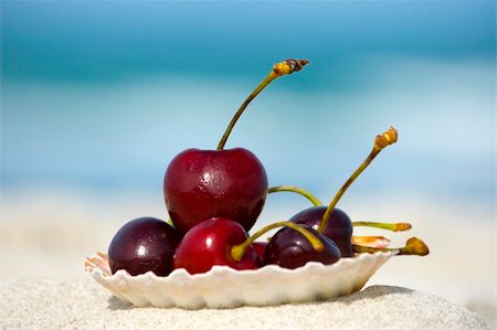 dreaming about eating - Fresh cherries in a seashell on the beach with sea on background. Summer food concept Stock Photo - Budget Royalty-Free & Subscription, Code: 400-04490292