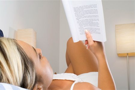 beautiful young woman with blond hair reading a book one evening in bed before to sleep Stock Photo - Budget Royalty-Free & Subscription, Code: 400-04491202