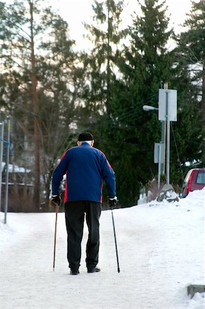 stick man on a road - An old man walking on a snowy road with two canes Stock Photo - Budget Royalty-Free & Subscription, Code: 400-04491366