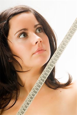 simsearch:400-03915883,k - nice portrait of a young brunette looking at the tape measure with surprise Stock Photo - Budget Royalty-Free & Subscription, Code: 400-04491611