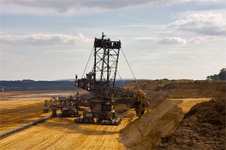 Giant bucket wheel excavator taking away the layers of ground before digging the brown coal. Stock Photo - Budget Royalty-Free & Subscription, Code: 400-04492231