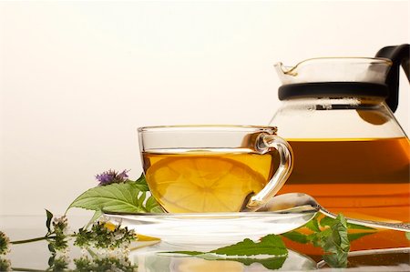 Tea pot with cup and leaves of mint and lemon-balm Stock Photo - Budget Royalty-Free & Subscription, Code: 400-04493724