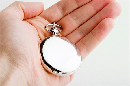 A male hand holding a fancy pocket watch Stock Photo - Budget Royalty-Free & Subscription, Code: 400-04493913